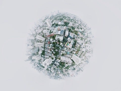 Globe with buildings and trees built on the surface