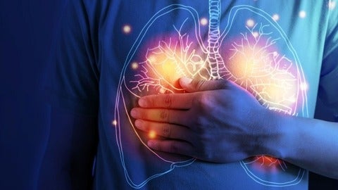 Illustration of lungs on a person's shirt. They are pressing their hand to the lungs.