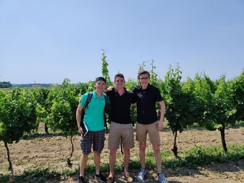 Jack Paduchowski and team standing in a vinyard