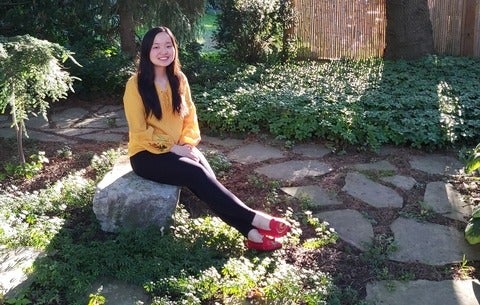 Maggie Chang sitting in a garden