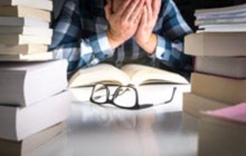 Stressed student with text books