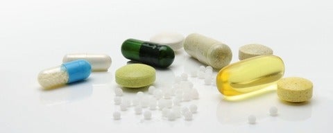 Assorted medical pills on a white surface