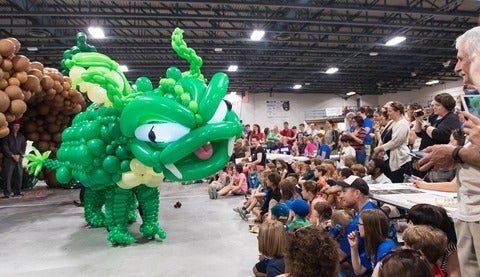 Audience marvels at a life-size balloon dragon