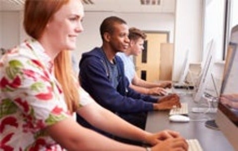 Male and female students working on a computers