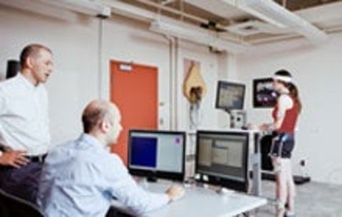 Researchers monitoring standing study participant