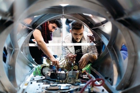 Two students working on the levitations system for the hyperloop pod 