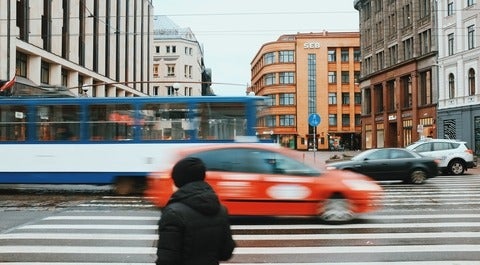 bus and car driving on an urban road