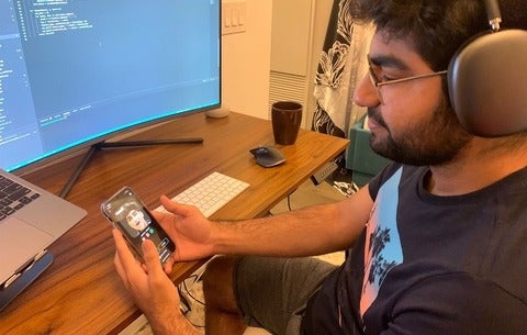 Parshant Utam looking at the Wombo app on his phone