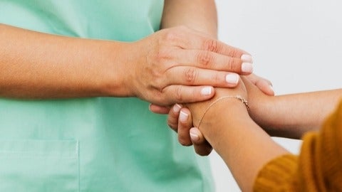 Nurse holding a patient's hand
