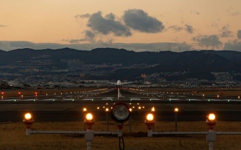Airplane on the tarmac about to take off during sunset