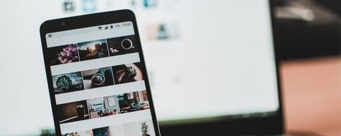 A black phone in front of laptop