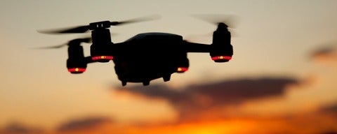 Drone flying towards sunset