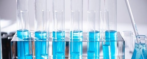A line of testing tubes with blue substance