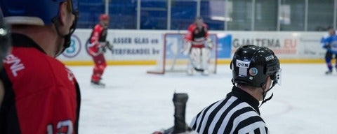 Referee in front of hockey ring
