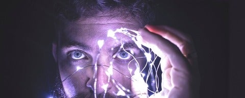 Person holding lights in front of face