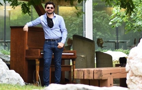 Max standing beside piano