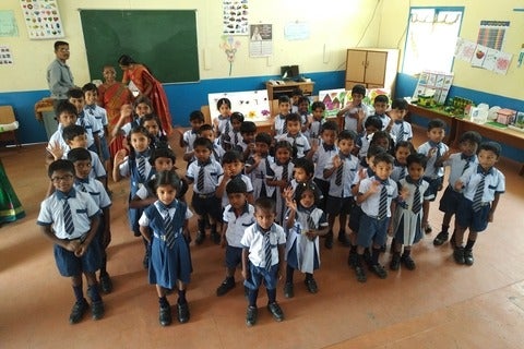 Michael Steele and Stacey Coote celebrate the construction of a school in rural India along with community members 