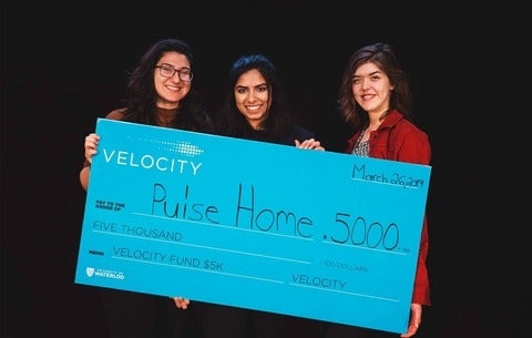 Emman Haider, Paula Przybylski and Sara Turner holding their cheque 