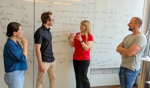Dr. Christine Muschik with researchers of the qudit quantum computer project