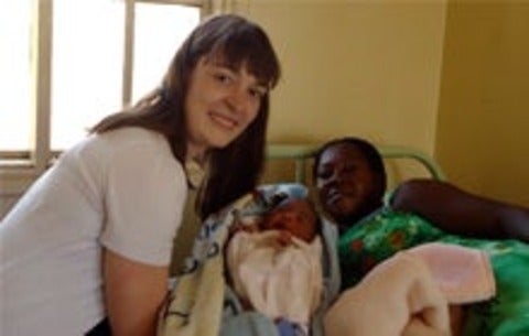 Christina Marchand with a mother and baby in Uganda