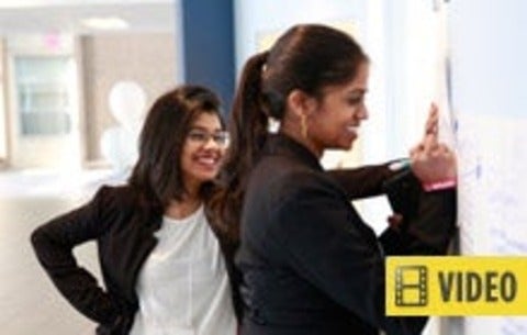 Two women writing down ideas - this story contains video