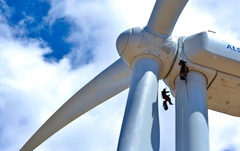wind turbine with two workers on rigging