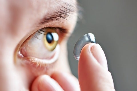 Someone putting in a contact lens