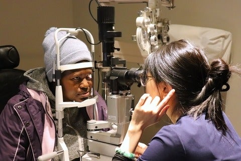 Person looking a slit lamp during eye exam