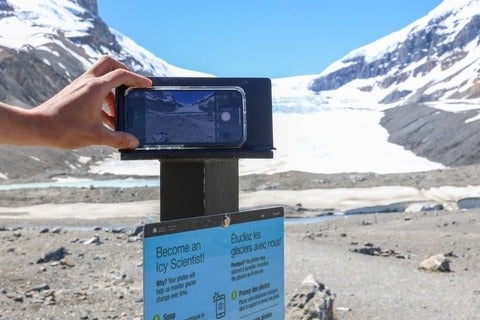 An iphone taking a photo of a glacier to help monitor the glacier over time.