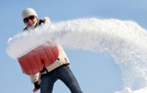 Woman shovelling snow