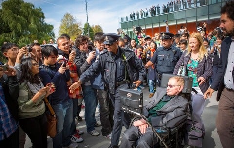 Stephen Hawking being greeted by crowds in 2012.
