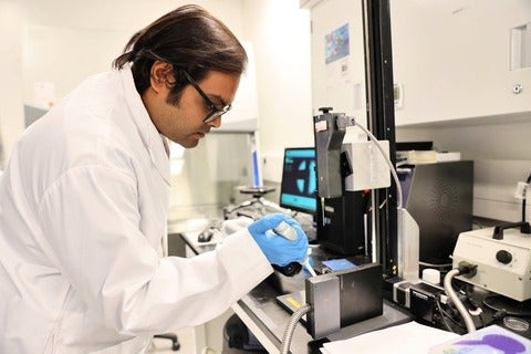 Dr. Surjyasish Mitra, a member of the Waterloo research team, dispenses a soft sphere on a vertical surface