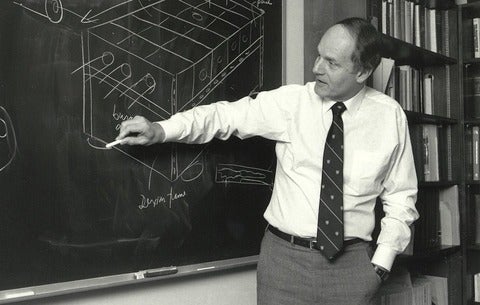 Thomas Bzrustowski lecturing in front of a blackboard