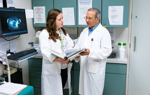 Co-op student speaking with doctor