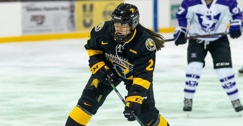 Trisha Cho on the ice in hockey gear