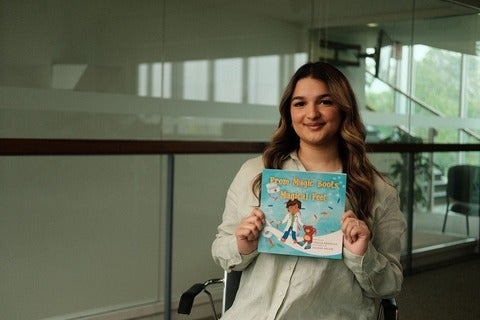 Unzila Shahzad holding her recently published children's book