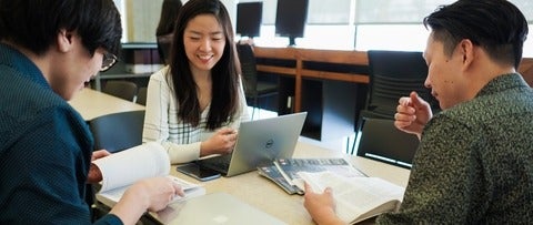 Students work in a team around a table