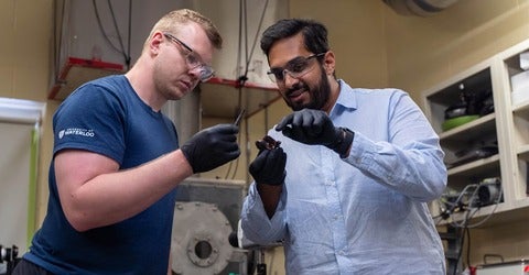 Graduate student Braden Southern and Dr. Vinny Gupta examine remnants of a battery cell