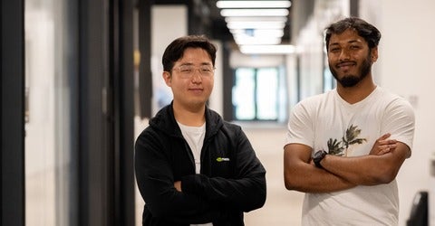 Seungmin Hong and Ahnaf Shahriar pose together with their arms crossed