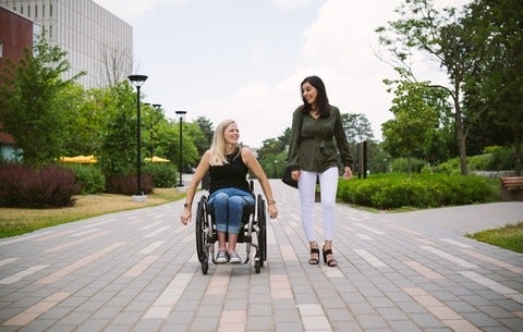 Woman wheelchair user and able-bodied friend on Waterloo campus