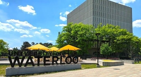 University of Waterloo sign outdoors on a summer day