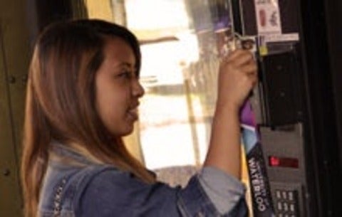 student making a purchase at a vending machine