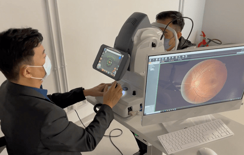 An ophthalmologist imaging the back of a patient's eye