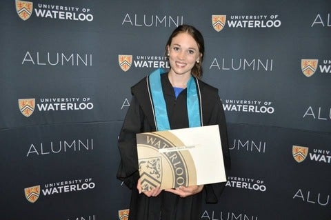 Victoria holding her diploma at convocation