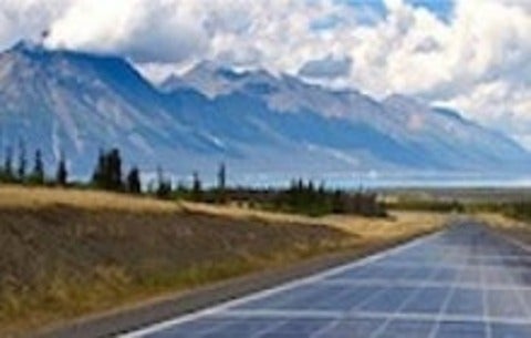 A road paved with solar panels runs to the horizon