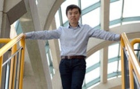 Grad student standing on stairs