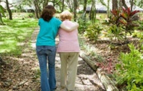 Young woman walks with a senior woman