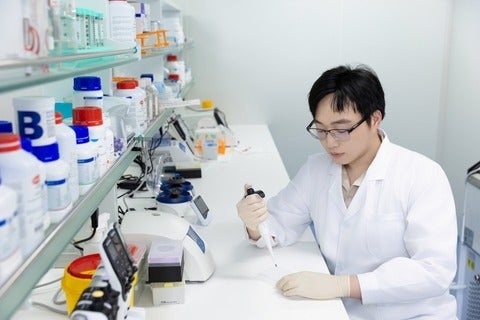 scientist in lab coat working in a laboratory