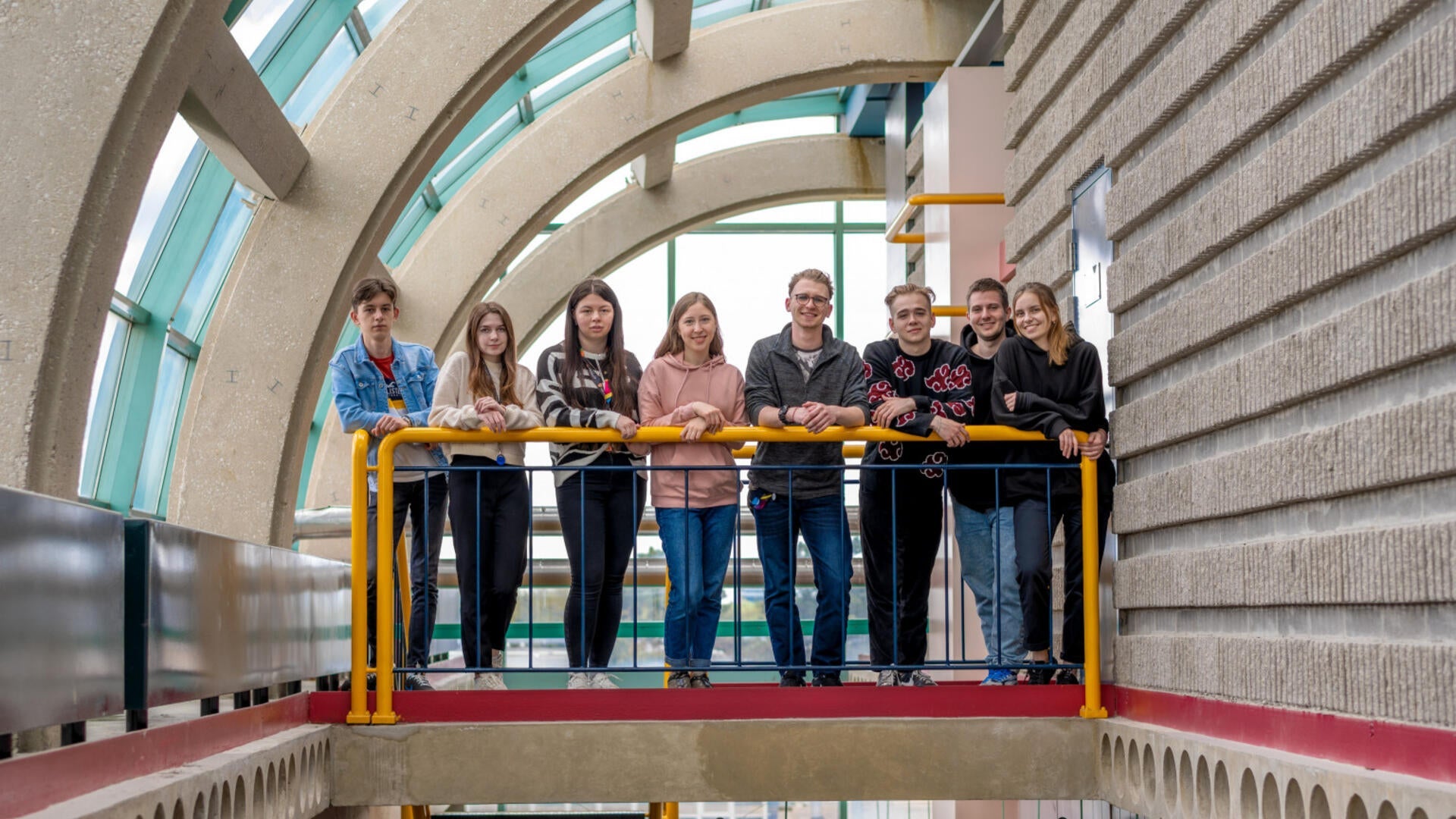 8 students standing in a row