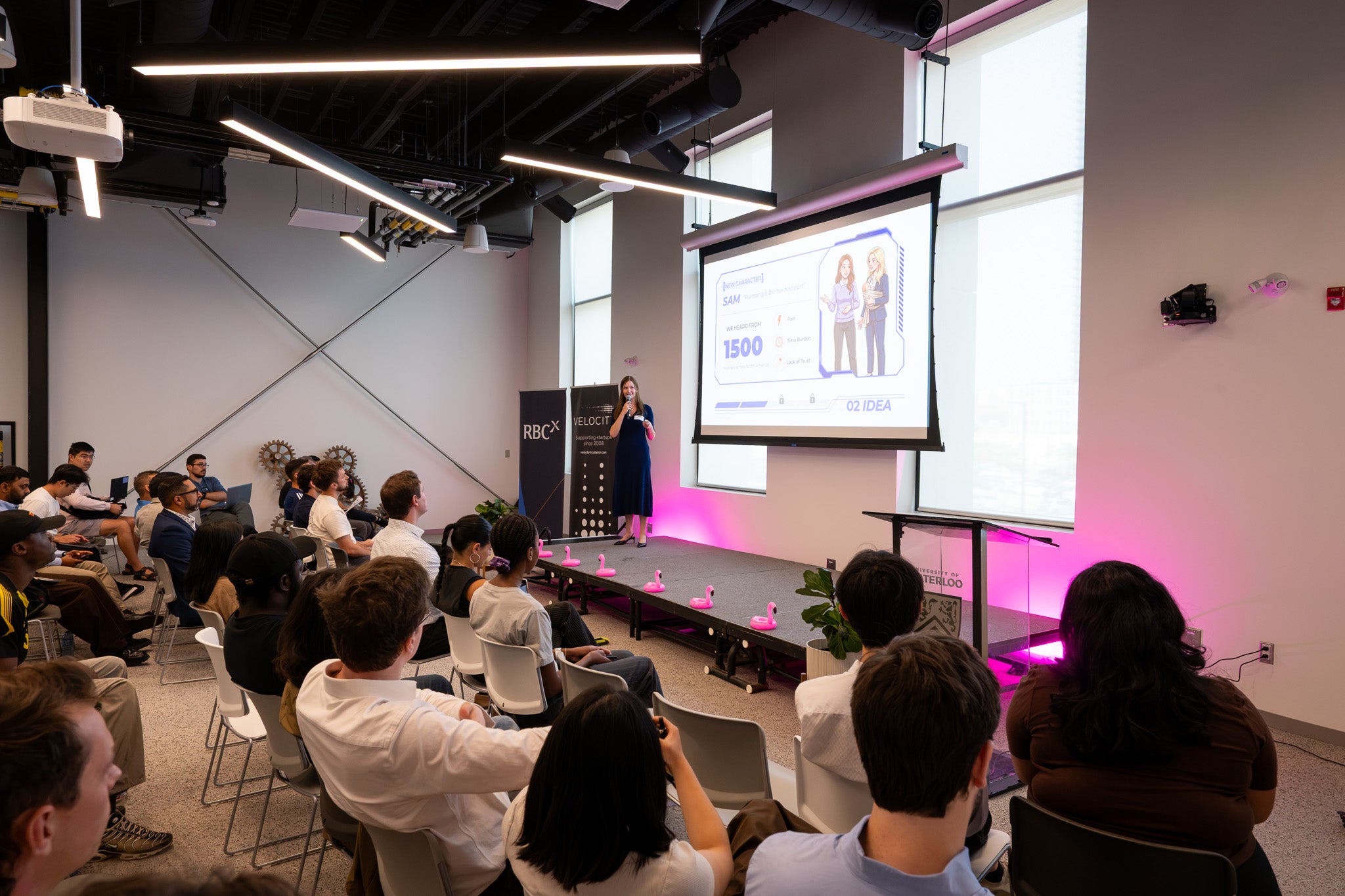 Ashley Juraschka presenting on stage in front of a room of startup founders at Velocity